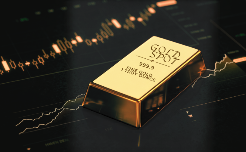 Polished gold spot bullion bar on a dark surface with glowing financial stock market candlestick charts and price metrics.